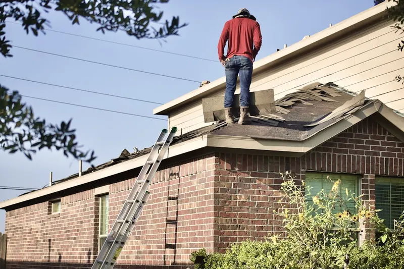 Professional roofer working on a residential roof in Marrero
